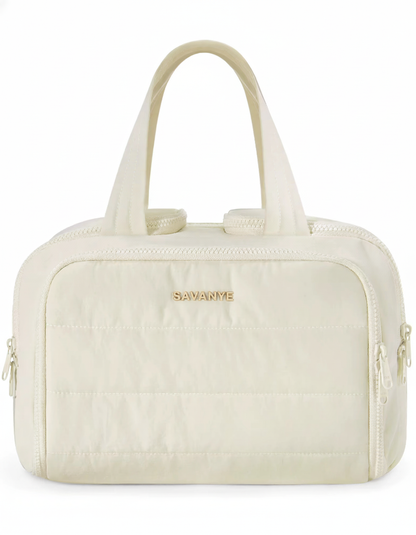 Beige handbag with gold zipper and 'Savanne' branding on a white background